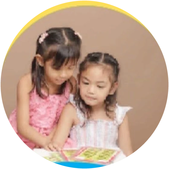 Two girls reading a picture book side by side